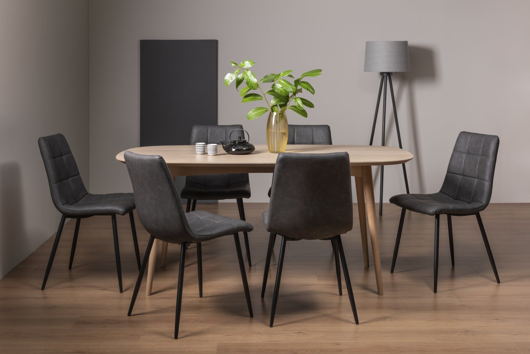 Dansk Scandi Oak 6 Seater Dining Table & 6 Mondrian Dark Grey Faux Leather Chairs with Sand Black Powder Coated Legs - Style Our Home